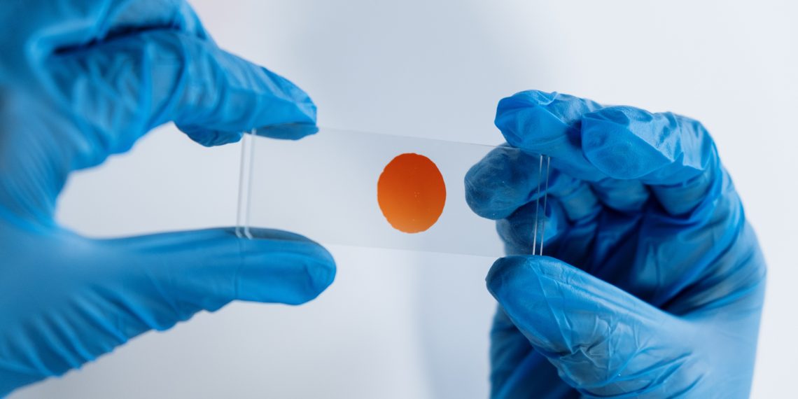 Drop of blood in a glass surface inside a lab