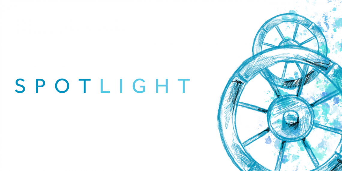 Illustration in tones of blue and green of a wheel. On the left side of the banner it reads "spotlight"